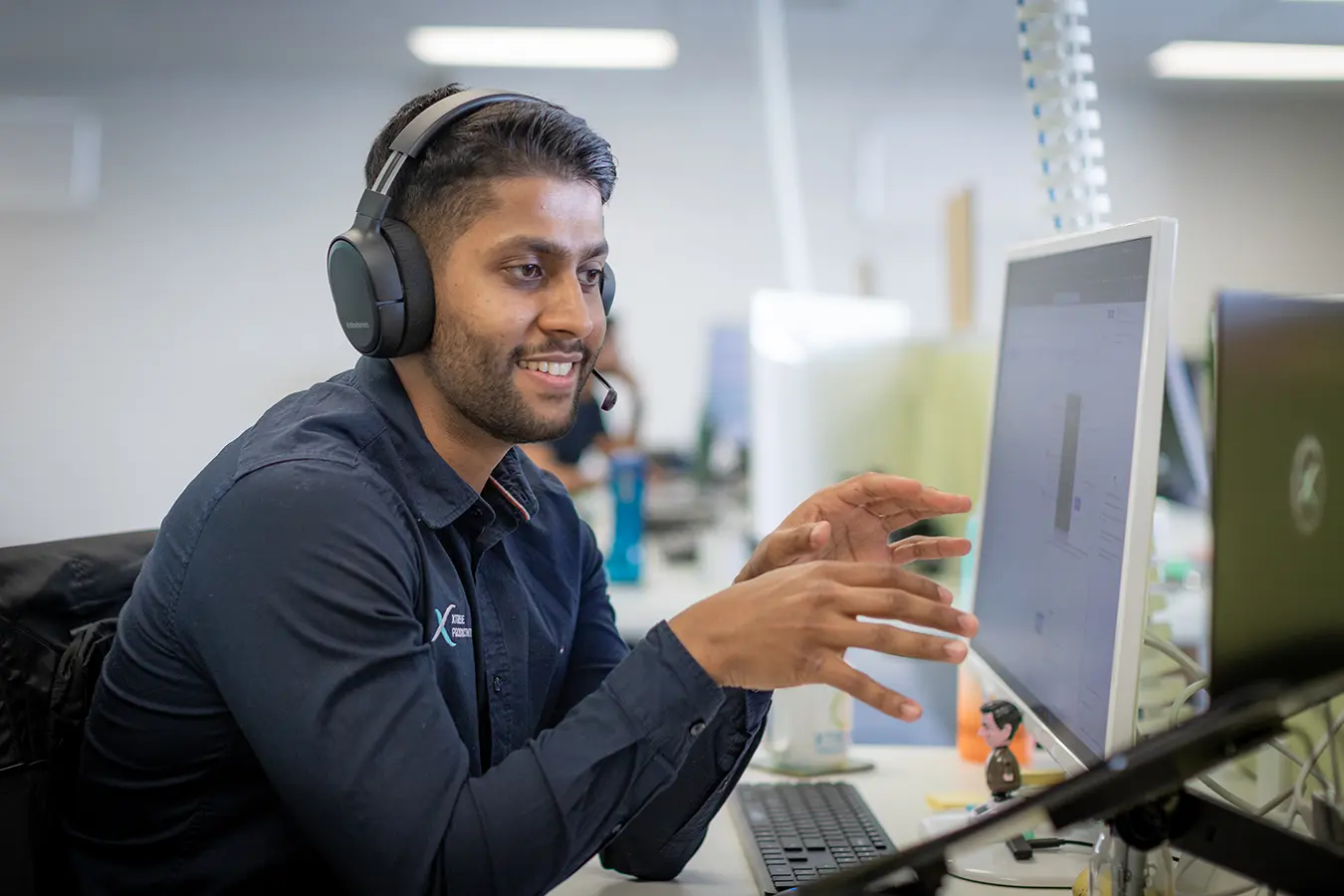 XP Staff wearing headset and talking on phone to client