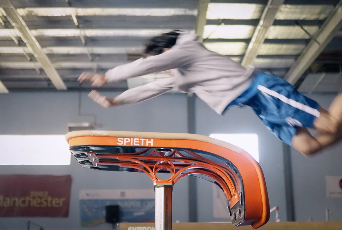 Gymnast springing across the vault mid-air