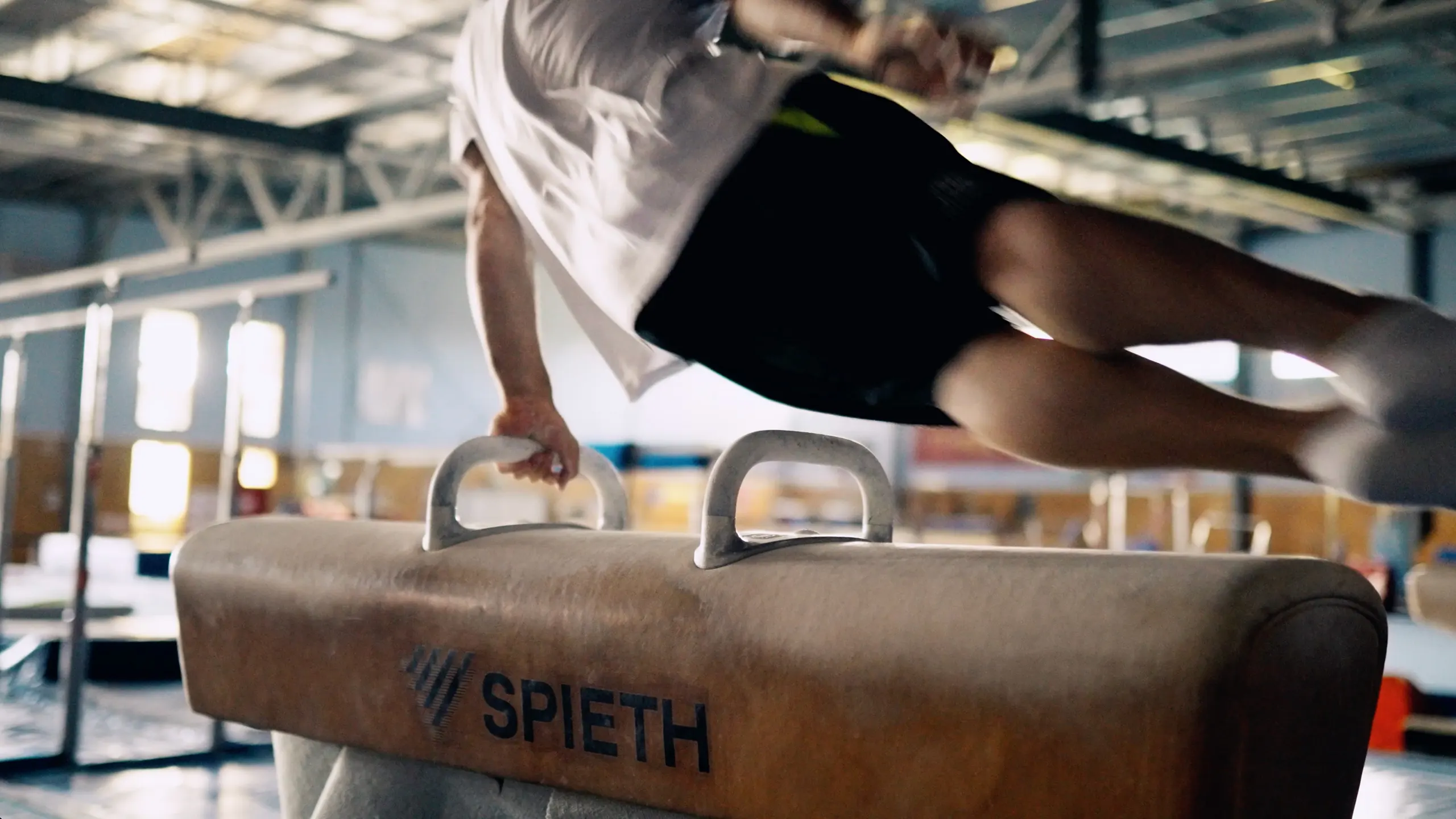 Gymnast rotating on a pommel horse