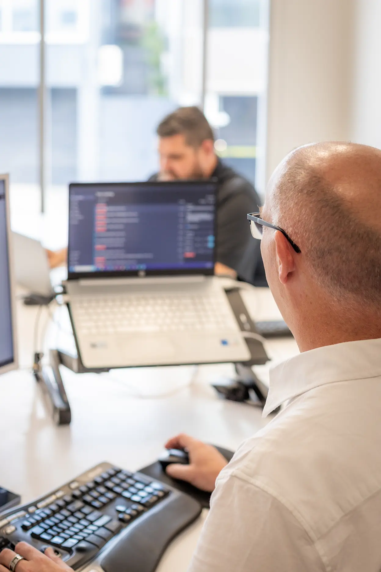 XP staff working on laptop and keyboard