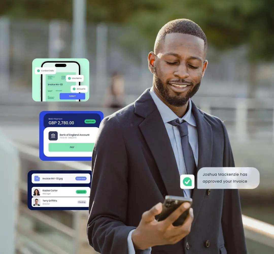 man smiling at his phone, his invoice just got approved through aprovalmax