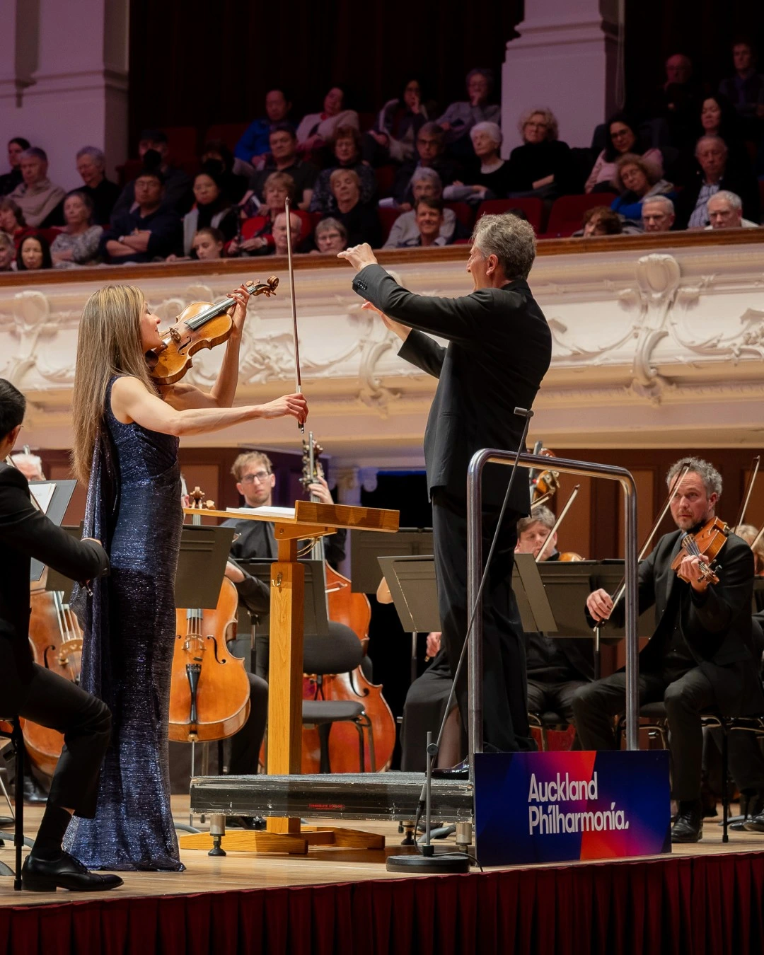 People conducting and playing at an orchestra