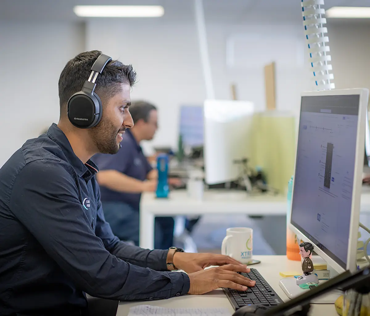 XP Staff member working in the office on a support call