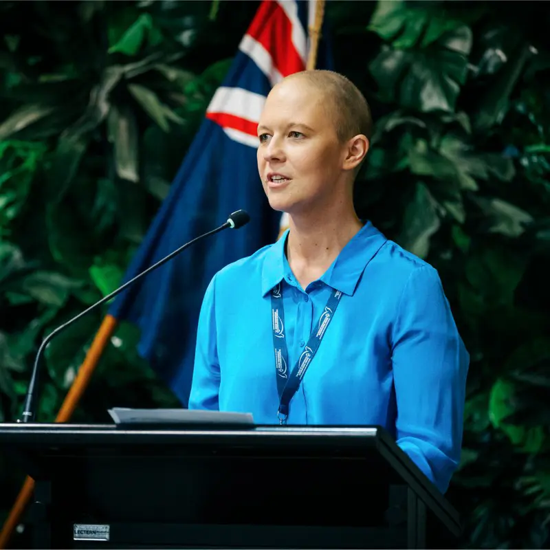 Emma brown CEO of duke of Edinburgh's Hillary Award. Standing and giving a presentation