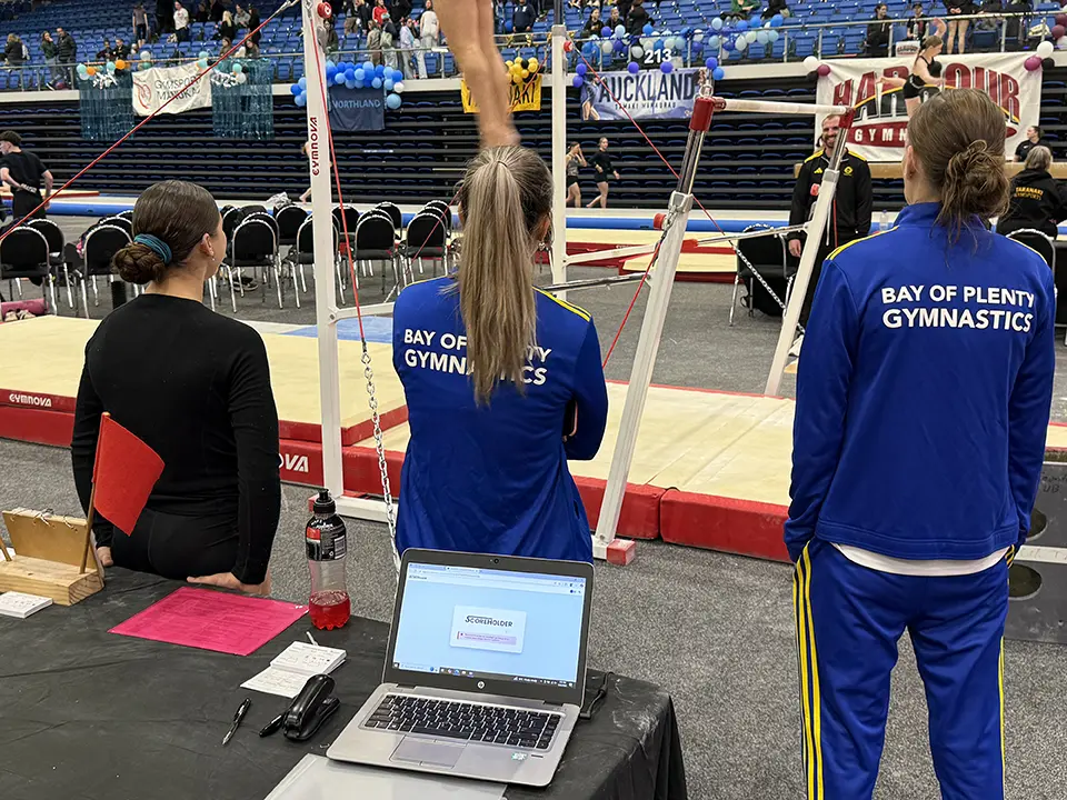 xtreme productivity scoring technology (a laptop) in front of a gymnastics routine at the XP gymnastics nationals 