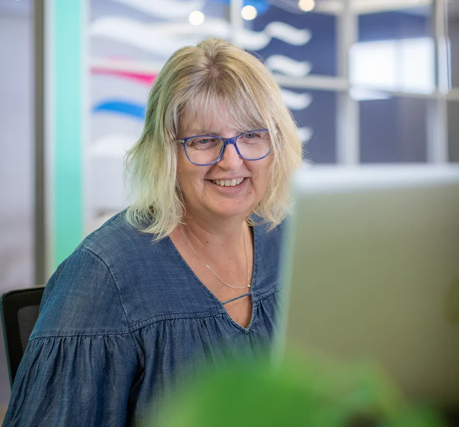 Xero partner sitting at desk using computer and smiling
